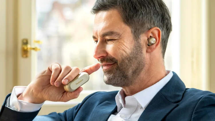 A person holding a device to his face AI-generated content may be incorrect.