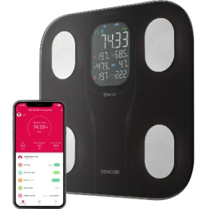 The image shows a black exercise band with a digital display, a fitness scale, and a smartphone, displaying the user's weight, Body Mass Index (BMI), and weight loss progress.Obsah generovaný pomocí AI může být nesprávný.